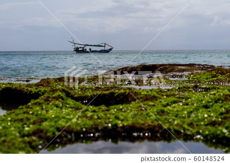 A boat floating on a blue sea A boat floating on a blue sea 60148524