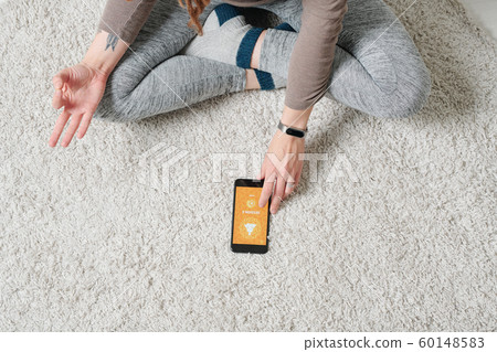 Crossed legs and hands of contemporary active girl doing yoga exercise Crossed legs and hands of contemporary active girl doing yoga exercise 60148583