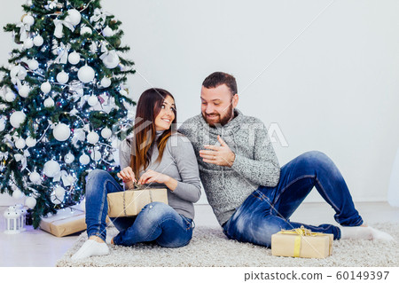 a guy with a girl open Gifts Christmas new year a guy with a girl open Gifts Christmas new year 60149397