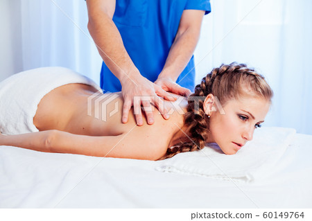 a woman doing a back massage in the Spa 1 60149764