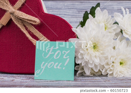 White flowers and red gift box. White flowers and red gift box. 60150723