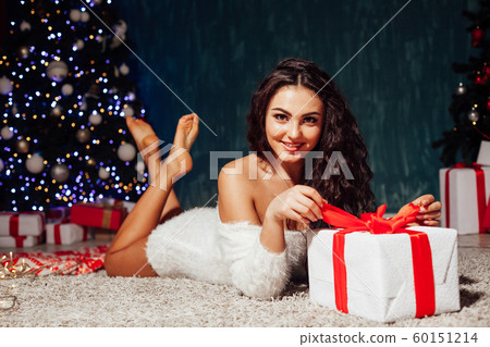 beautiful woman at the Christmas tree with gifts of decor for the new year 60151214