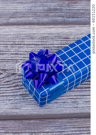 Blue gift box with white plaids. 60151220