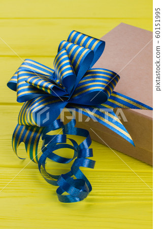 Cardboard gift box with blue striped ribbon bow knot. 60151995