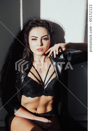 Portrait of a beautiful fashionable woman in black underwear in the bedroom Portrait of a beautiful fashionable woman in black underwear in the bedroom 60152122