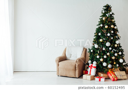 Christmas tree with gifts Of December decor in the interior of the white room as a background Christmas tree with gifts Of December decor in the interior of the white room as a background 60152495