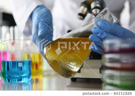 Person doing experiment with ampoule Person doing experiment with ampoule 60152888