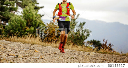 young male runner with camelbak young male runner with camelbak 60153617