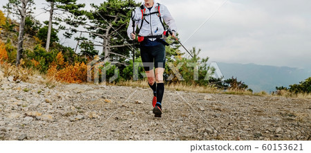 male runner with trekking poles male runner with trekking poles 60153621