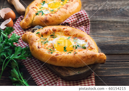 Khachapuri Ajarian on rustic wooden background 60154215
