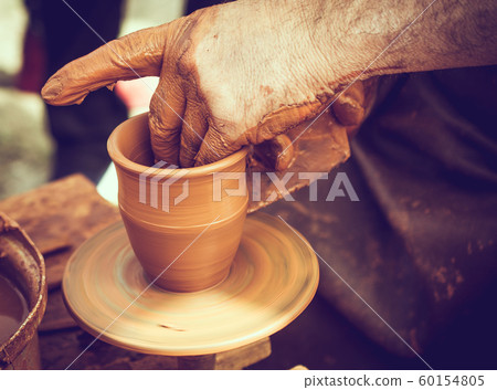 Potter`s hands shaping up the clay Potter`s hands shaping up the clay 60154805