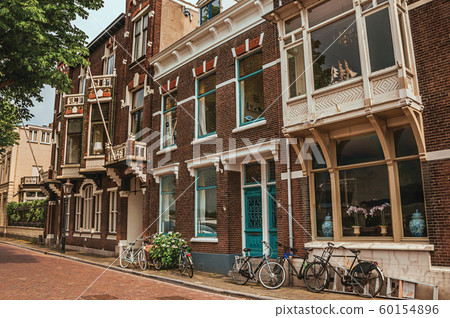 Elegant brick buildings and bicycles on a street of Dordrecht Elegant brick buildings and bicycles on a street of Dordrecht 60154896