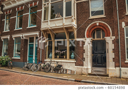 Elegant brick building and bicycles on a street of Dordrecht Elegant brick building and bicycles on a street of Dordrecht 60154898