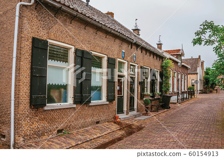 Charming and quiet street with brick rustic house at Drimmelen 60154913