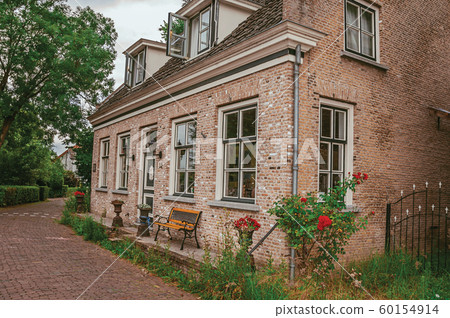Charming and quiet street with brick rustic houses at Drimmelen Charming and quiet street with brick rustic houses at Drimmelen 60154914