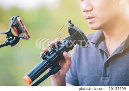 Close-up Singer holding a microphone stand and Close-up Singer holding a microphone stand and 60155899