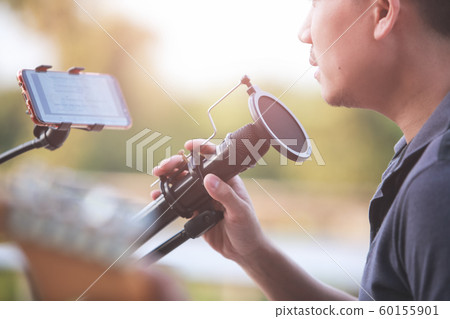 Close-up Singer holding a microphone stand and 60155901