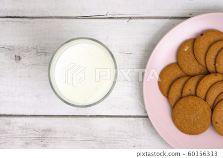 Glass of milk and cookies on the table close-up. 60156313