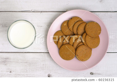 Glass of milk and cookies on the table close-up. 60156315
