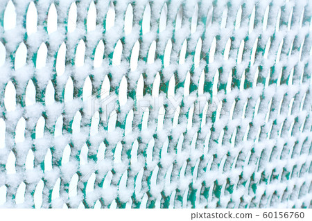 Mesh fence lattice crushed by snow close up 60156760