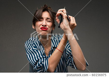Happy caucasian woman do haircut and cry isolated on grey background 60156975