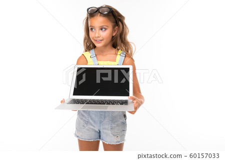 attractive european girl with glasses holding a computer in her hands with mockup on a light blue attractive european girl with glasses holding a computer in her hands with mockup on a light blue 60157033