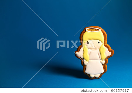 gingerbread cookie of cute little angels on blue 60157917