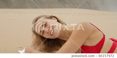 Sexy girl poses for the camera - happy girl on summer vacation at the beach Sexy girl poses for the camera - happy girl on summer vacation at the beach 60157972