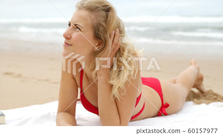 A relaxing day on a sandy beach at the ocean A relaxing day on a sandy beach at the ocean 60157977