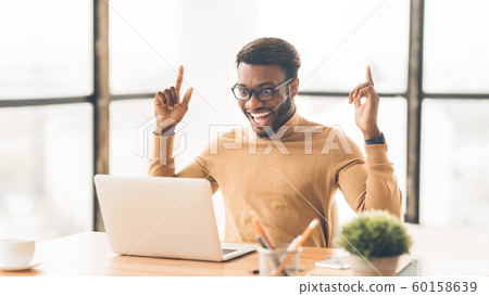 Happy african american guy celebrating his triumph Happy african american guy celebrating his triumph 60158639