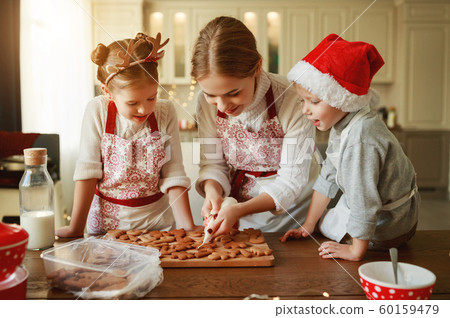 happy family mother and children bake christmas 60159479