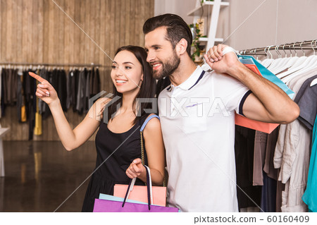 Young adult husband and wife walking in shopping mall Young adult husband and wife walking in shopping mall 60160409