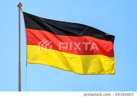 The national flags of Germany on the background of clear blue sky. 60160805