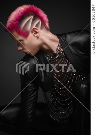 Young man with pink hair and creative makeup in art clothes. Young man with pink hair and creative makeup in art clothes. 60162047
