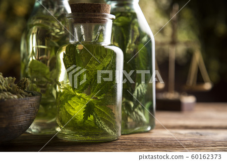 Oil and Natural medicine, wooden table background 60162373