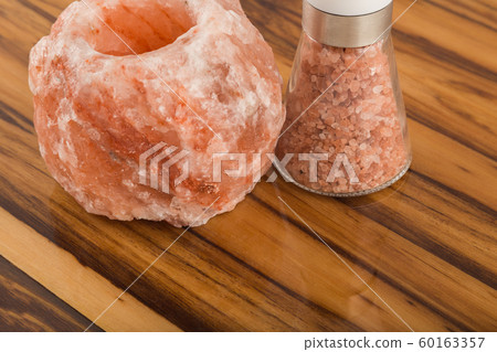 Natural salt and salt shaker on the varnished 60163357