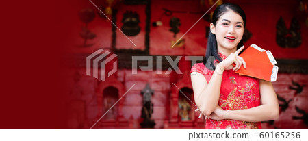 Beauty Asian woman wearing a red cheongsam 60165256