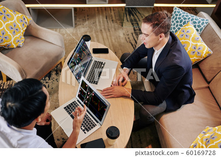 Businessmen analyzing investment strategy Businessmen analyzing investment strategy 60169728