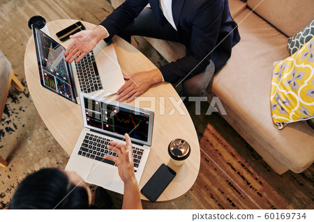Financial analysts discussing charts 60169734