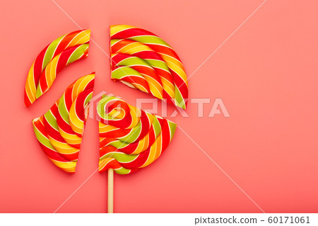 Lollipop broken into pieces on pink background, 60171061