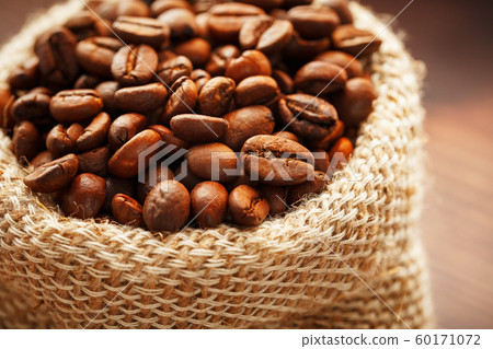Coffee beans closeup in burlap bag on wooden 60171072