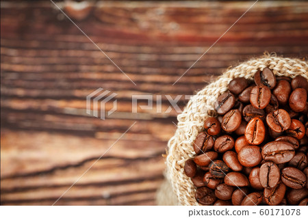 Coffee beans closeup in burlap bag on wooden 60171078