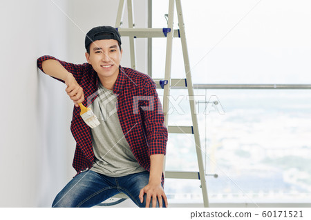 Cheerful man with paint brush Cheerful man with paint brush 60171521