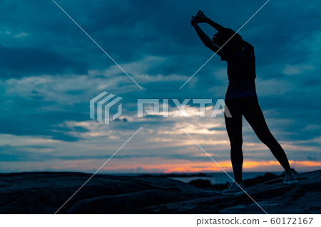 Silhouette woman workout in the morning at stone 60172167