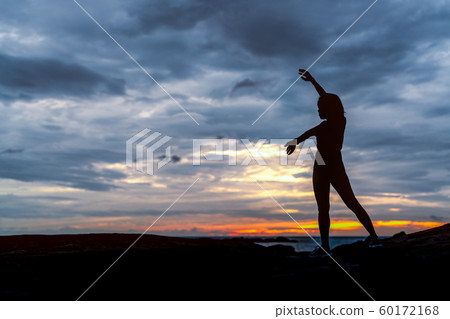 Silhouette woman workout in the morning at stone 60172168