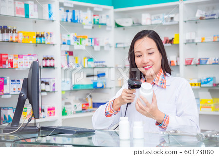 Beautiful asian pharmacist standing in drugstore 60173080
