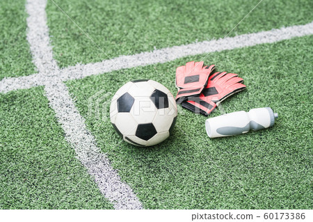 Group of sports gear - soccer ball, leather gloves and plastic bottle of water Group of sports gear - soccer ball, leather gloves and plastic bottle of water 60173386
