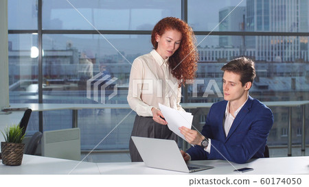 Female employee of the company brings financial documents to his boss 60174050