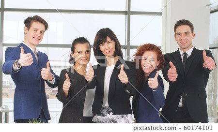 Office and teamwork concept, group of business people having a meeting and showing thumbs up. 60174101