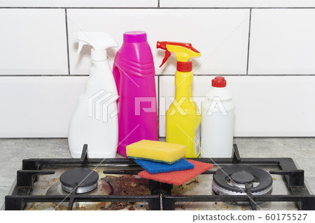 Dirty, top of the gas stove with bits of food. Dirty, top of the gas stove with bits of food. 60175527